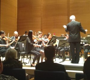iqing Rose Chen, serving as concertmaster of Tufts Youth Philharmonic in May 2015, with conductor John Page